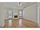Bright living room featuring a fireplace, wood floors and a ceiling fan at 110 Cloverwood Dr, Fayetteville, GA 30215