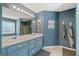 Bathroom featuring a double sink vanity, shower, and large mirror with Hollywood lights at 232 Taylors Farm Dr, Canton, GA 30115