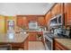 Well-appointed kitchen with stainless steel appliances, granite countertops, wood cabinets and eat-in island at 232 Taylors Farm Dr, Canton, GA 30115