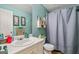 Cozy bathroom with a single sink vanity, framed mirror, and shower with a gray curtain at 232 Taylors Farm Dr, Canton, GA 30115