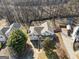 Aerial view of home with two-car garage, long driveway, fenced yard, and mature trees surrounding the property at 232 Taylors Farm Dr, Canton, GA 30115
