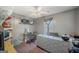 Well-lit bedroom features a large window, ceiling fan, and a workspace at 232 Taylors Farm Dr, Canton, GA 30115