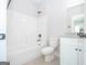Bathroom with a white bathtub, toilet and granite countertop vanity at 69 Oakhurst Trl, Sharpsburg, GA 30277