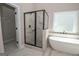 Spa-like bathroom featuring a large walk-in shower and a free-standing tub at 69 Oakhurst Trl, Sharpsburg, GA 30277
