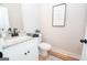 Small bathroom with white vanity, granite countertop, and black fixtures at 69 Oakhurst Trl, Sharpsburg, GA 30277