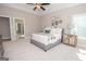 Main bedroom with ceiling fan, large windows, and carpeted floor at 69 Oakhurst Trl, Sharpsburg, GA 30277