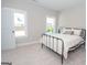 Spacious bedroom with a metal bed frame and neutral decor at 69 Oakhurst Trl, Sharpsburg, GA 30277