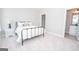 Bedroom with a metal bed frame, nightstand, and en-suite bathroom at 69 Oakhurst Trl, Sharpsburg, GA 30277