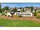 Entrance sign for Twelve Parks community with houses in background at 69 Oakhurst Trl, Sharpsburg, GA 30277