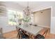Bright dining room features a large table, chandelier, and hardwood floors at 69 Oakhurst Trl, Sharpsburg, GA 30277