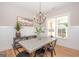 Dining room features concrete table, chandelier, and hardwood floors at 69 Oakhurst Trl, Sharpsburg, GA 30277