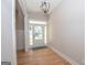 Bright entryway with hardwood floors and chandelier at 69 Oakhurst Trl, Sharpsburg, GA 30277