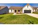 White farmhouse exterior with a large yard and two-car garage at 69 Oakhurst Trl, Sharpsburg, GA 30277
