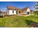 White farmhouse exterior with a large yard and two-car garage at 69 Oakhurst Trl, Sharpsburg, GA 30277