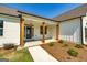 Front porch with wooden columns and landscaping at 69 Oakhurst Trl, Sharpsburg, GA 30277