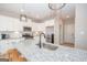 Modern kitchen with white cabinets, granite island, and black faucet at 69 Oakhurst Trl, Sharpsburg, GA 30277
