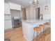 Island kitchen with granite countertops and three wooden barstools at 69 Oakhurst Trl, Sharpsburg, GA 30277
