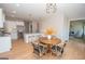 Modern kitchen with white cabinets, granite counters, and stylish lighting at 69 Oakhurst Trl, Sharpsburg, GA 30277