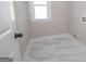 Bright laundry room with white tile floor and a window at 69 Oakhurst Trl, Sharpsburg, GA 30277