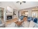 Living room with stone fireplace, hardwood floors, and ample natural light at 69 Oakhurst Trl, Sharpsburg, GA 30277