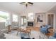 Living room with stone fireplace, hardwood floors, and ample natural light at 69 Oakhurst Trl, Sharpsburg, GA 30277