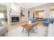 Living room with stone fireplace, hardwood floors, and ample natural light at 69 Oakhurst Trl, Sharpsburg, GA 30277