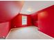 Red-walled bedroom with sloped ceilings and a window at 504 Serene Waters Trl, Jonesboro, GA 30236