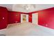 Large bedroom with red walls and ceiling fan at 504 Serene Waters Trl, Jonesboro, GA 30236