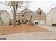Brick two-story house with a two-car garage and mature trees at 504 Serene Waters Trl, Jonesboro, GA 30236