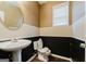 Small powder room with pedestal sink and toilet at 504 Serene Waters Trl, Jonesboro, GA 30236