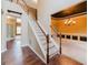 Elegant staircase with hardwood floors and white railings at 504 Serene Waters Trl, Jonesboro, GA 30236