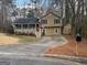 Charming home featuring a covered front porch, American flag, and cozy curb appeal at 3025 Sumit Wood Nw Dr, Kennesaw, GA 30152