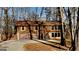 Exterior view of a home featuring a two-car garage and wooded surroundings at 2395 River Run Dr, Douglasville, GA 30135