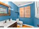 Stylish bathroom with blue walls and decorative wall art at 150 S Kite Lake Rd, Fayetteville, GA 30214