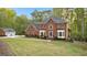 Two-story brick home with a large front yard and detached garage at 150 S Kite Lake Rd, Fayetteville, GA 30214