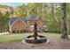 Brick house with a fountain and landscaping in the front at 150 S Kite Lake Rd, Fayetteville, GA 30214