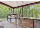 Stainless steel appliances and stone countertops highlight this outdoor kitchen at 150 S Kite Lake Rd, Fayetteville, GA 30214