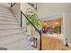 Elegant staircase with carpet runner and view into living area at 150 S Kite Lake Rd, Fayetteville, GA 30214