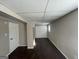 Finished basement with dark hardwood floors and built-in shelving at 730 N Carter Dr, Jonesboro, GA 30236