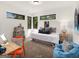 Bright bedroom with a playful decor, including a blue beanbag chair, stacked trunks, and modern desk at 200 Simonton Rd, Lawrenceville, GA 30046