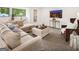 Cozy living room featuring a sectional couch, an ottoman, and a modern television for entertainment at 200 Simonton Rd, Lawrenceville, GA 30046
