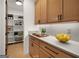Well-organized pantry with ample shelving and storage adjacent to modern kitchen with light wood cabinets at 200 Simonton Rd, Lawrenceville, GA 30046