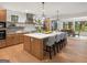 Open-concept kitchen with a large island, stainless steel appliances, and adjacent dining area with nature views at 200 Simonton Rd, Lawrenceville, GA 30046