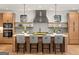 Bright kitchen featuring a large island, modern lighting, stainless steel appliances, and light wood cabinetry at 200 Simonton Rd, Lawrenceville, GA 30046