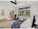 Bright main bedroom with sliding barn door to bathroom, large windows, and forest views at 200 Simonton Rd, Lawrenceville, GA 30046