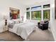 Serene bedroom with neutral tones, large window, elegant furnishings, and plush armchair for relaxation at 200 Simonton Rd, Lawrenceville, GA 30046