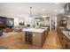 Modern kitchen with a wine fridge, a large island, stainless steel appliances, and open layout to the living area at 200 Simonton Rd, Lawrenceville, GA 30046