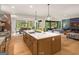 Bright, open kitchen connected to the living room and dining area, showcasing a large island and modern appliances at 200 Simonton Rd, Lawrenceville, GA 30046