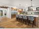 Spacious kitchen island with bar seating, stainless steel refrigerator, and modern pendant lighting at 200 Simonton Rd, Lawrenceville, GA 30046
