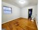 Spacious bedroom featuring hardwood floors and a view of the backyard at 485 Evergreen Dr, Forest Park, GA 30297